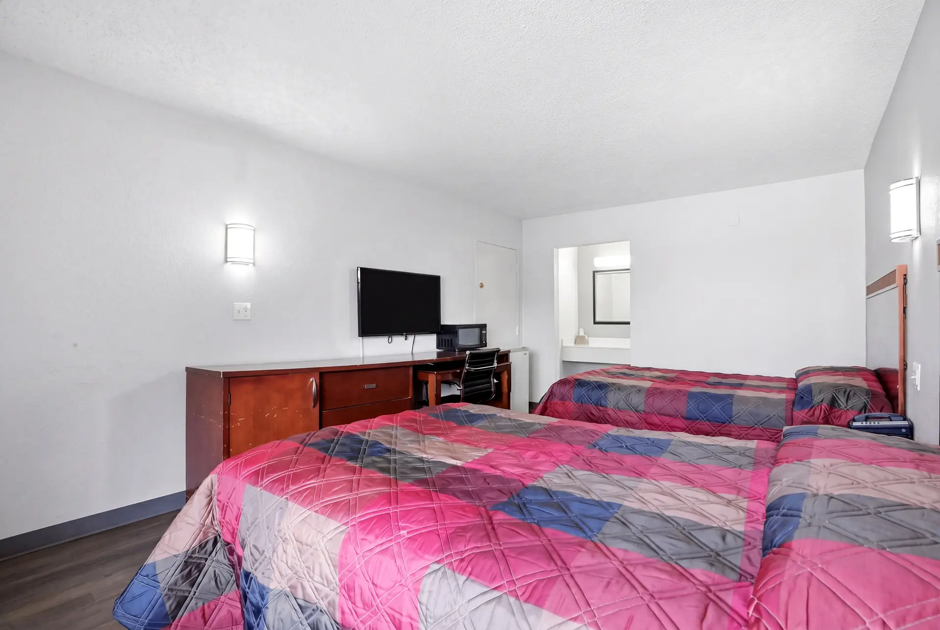Guest room set up for a longer stay at American Inn & Suites