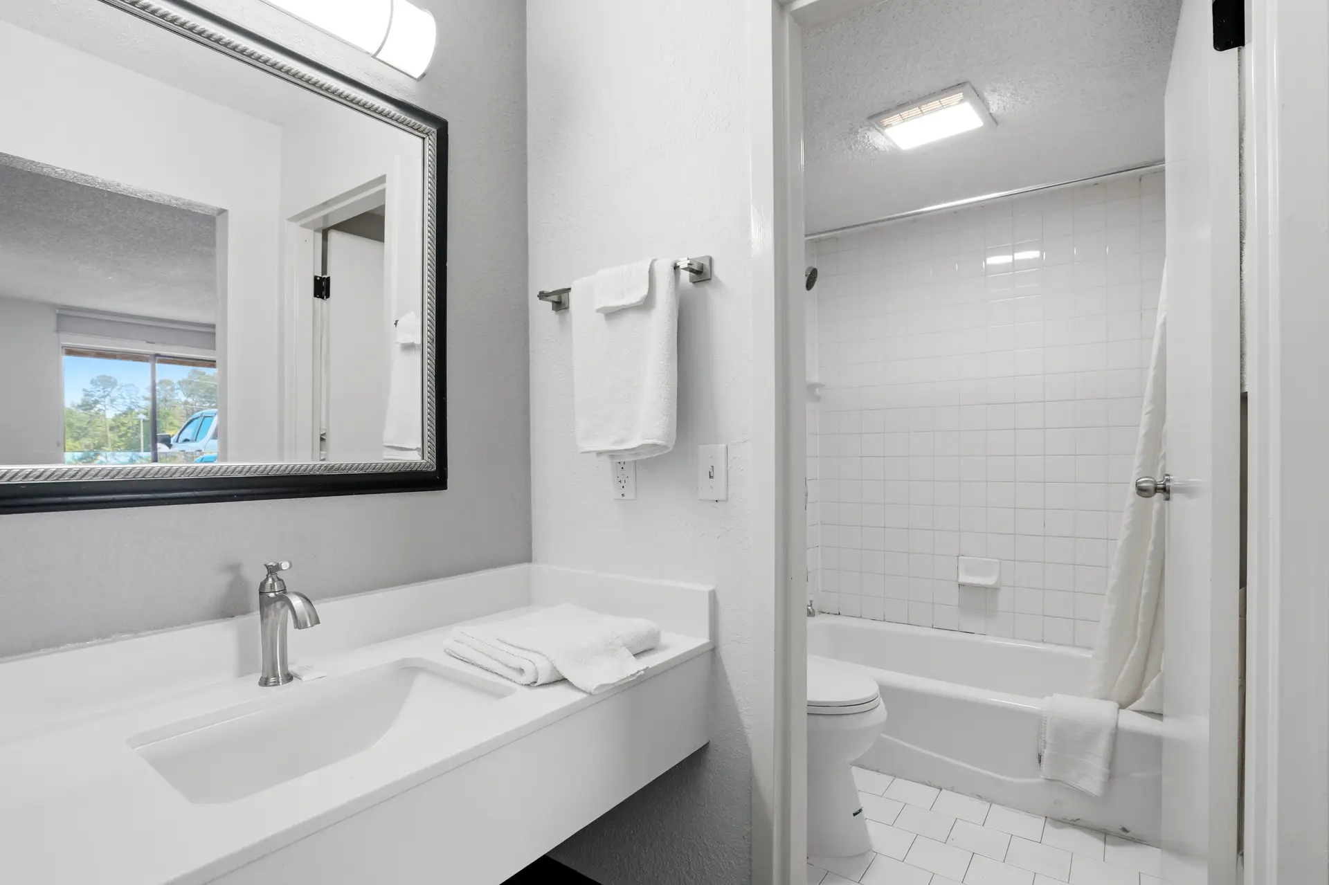 Private bathroom in a guest room at American Inn & Suites